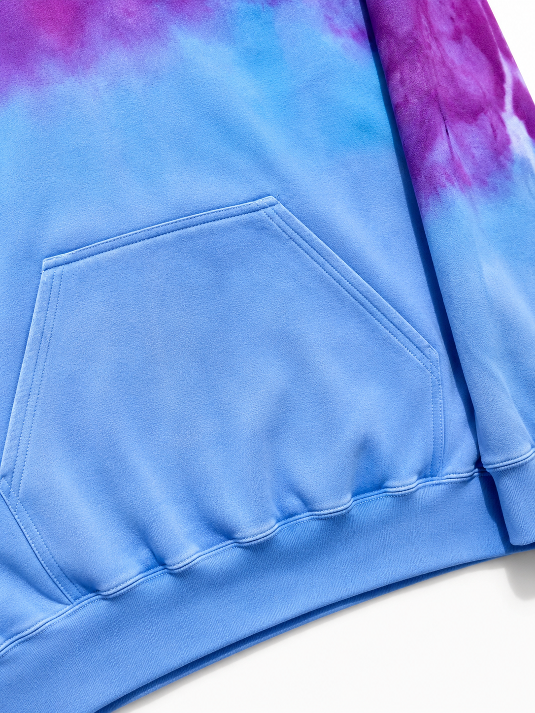 Close-up of a blue tie-dye hoodie with a pocket on a white background